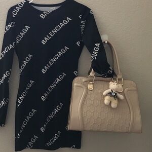 Designer handbag with teddy bear charm